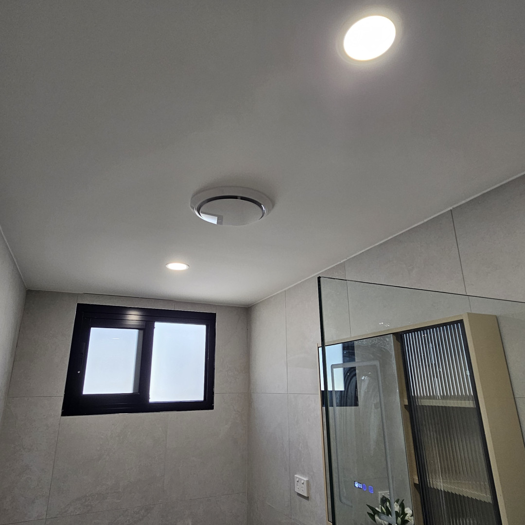 Tiled Charlestown bathroom with an oyster ceiling light, downlight and exhaust fan above a glass shower screen